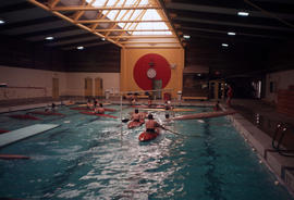 [Kayakers in indoor pool]