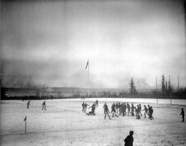 Boys playing rugby on snow covered field at Brockton Point
