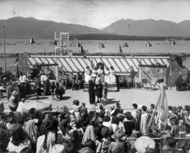 [A man speaking to clowns and other activities on stage in front of Kitsilano Pool for Kitsilano ...