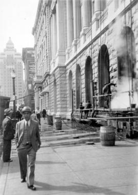 [Men on scaffold cleaning the exterior of the Post Office - 701 West Hastings Street for the civi...