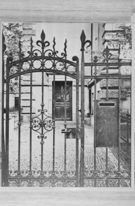 [Detail of metal gate - image of printed photograph]