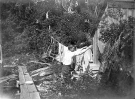 [Robert Jamieson hanging laundry, Good Hope Cannery, Rivers Inlet]