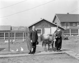 Detective and Mrs. McLaughlin in yard [1938 Wolfe Street] with chickens and cow