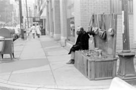 Street vendor selling bags and knicknacks on Gastown corner