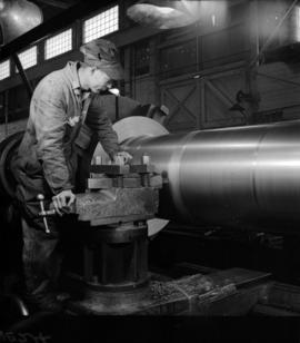 [Man working on a large pipe at Vancouver Engineering Works]