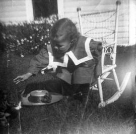 [Theodore Taylor sitting in rocking chair in yard of home at Willow Street and 8th Avenue in Fair...