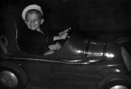 Child on amusement ride in P.N.E. Kiddieland