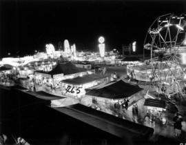 Illuminated P.N.E. Gayway amusement rides and tents at night