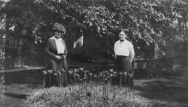 Adaline Hendry with a friend standing in a garden