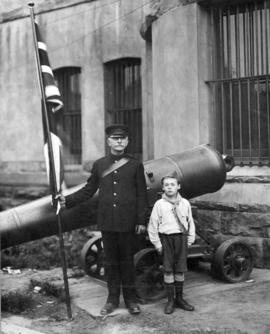 [Mr. W.J. Davis and young boy in front of "The Drill Hall", Beatty St.]