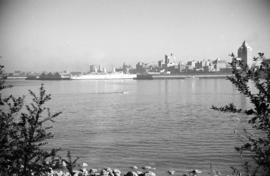 [View of an "Empress" ship at dock and Downtown from Stanley Park]