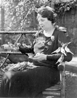 [A woman feeding the birds at Charles E. Jones' Birds' Paradise]