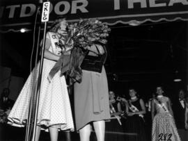 Glenda Sjoberg, winner of Miss P.N.E. 1955, receiving roses on Outdoor Theatre stage