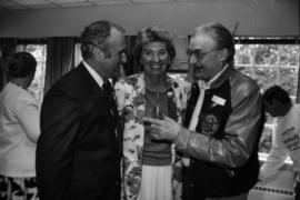 Group talking indoors at Centennial birthday party