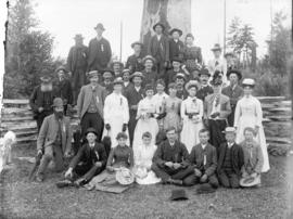[Men, women and children assembled in front of fence near Tom Turner's orchard for picnic]