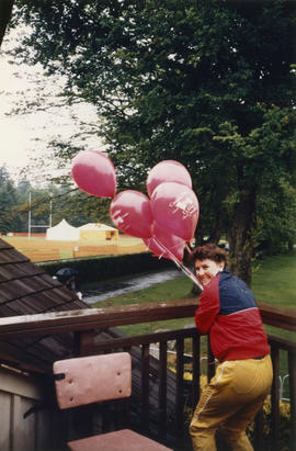 Woman with Canada Day balloons on Brockton Clubhouse deck