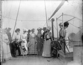 [Women's field hockey team, in formal dress, on deck of ferry to Victoria]
