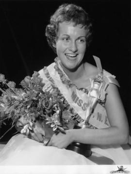 Portrait of Sharon Durham, Miss P.N.E. 1958, posing with flowers and trophy
