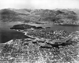 [Aerial view of Vancouver showing West and North Vancouver in the distance]