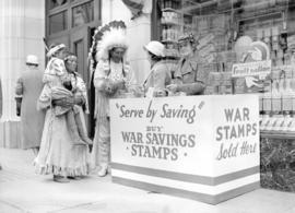 [Stoney Indians buying war savings stamps at a War Savings booth on the street]