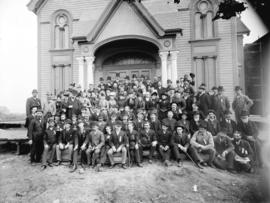 [Men and women assembled outside First Baptist Church, at the southwest corner of Dunsmuir and Ha...