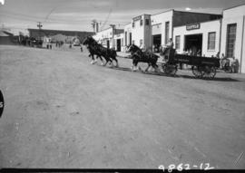 Four-horse team pulling W. Shepherd wagon by Livestock building on P.N.E. grounds