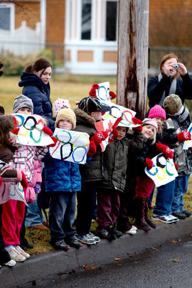 New Day 27 Children wave their Olympic Rings as the flame passes in New Brunswick.