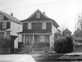 [View of "old" (ca 1909?) one-and-one-half storey house at 724-726 East 7th Avenue]