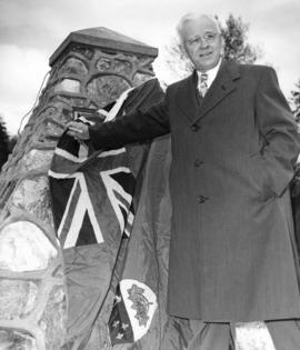 [John Rodger Burnes unveils stone cairn erected to commemorate the Lillooet Trail]