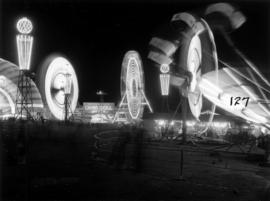 Illuminated amusement rides in P.N.E. Gayway at night
