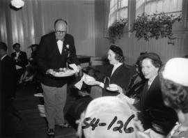 P.N.E. director J. Dunsmuir serving snacks at tea party