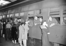 [Troops leaning out of train windows to say farewell to friends and family on the CNR station pla...