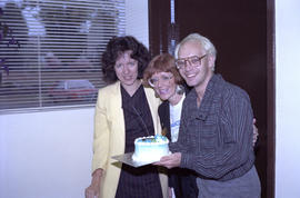 Centennial staff holding a cake