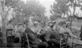 [Emily Matthews at table with nurses and soldiers]
