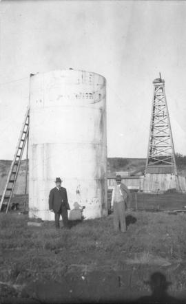 Oil country - [L.D. Taylor and Dr. Grossman in front of Dingman well, Turner Valley, Alberta]
