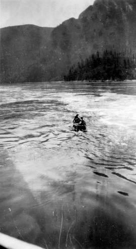 [Men in canoe, Stuart Island, B.C.]