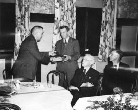 [E.W. Arnott, Vice President of B.C. Electric Railway presents a gavel to Fred Saunders to commem...