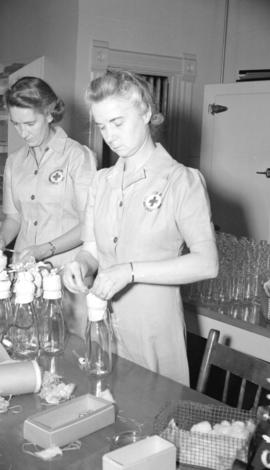 [Nurses at work in the blood donor lab on Hornby Street]