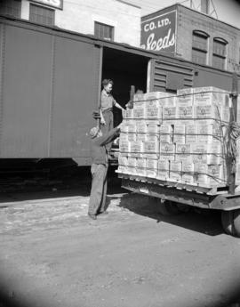 [Boxes of Hedlund's meat products being loaded into a railcar from a truck]