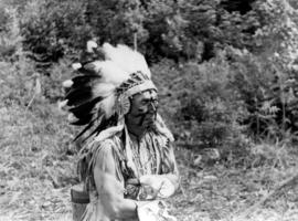 [Chief Joe Capilano wearing a feather headdress during the royal visit]