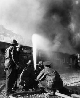 Benson's Shipyard fire [view of firefighters aiming hose at fire]