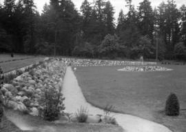 View of a garden with a fountain, possibly in a cemetery