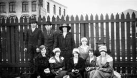 Refinery 'pickets' [men and women in front of a picket fence in refinery yeard]