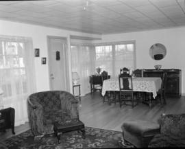 [Interior view of a house, showing the dining room and living room]