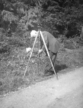 [John Rodger Burnes setting up a survey point on Hoskins Road]