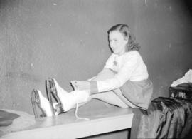 Miss Patricia Burley putting on skates