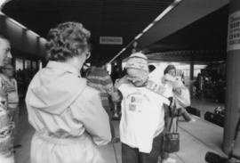 Woman holding up Heritage Walk t-shirt