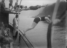 Swimmers diving off a boat