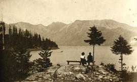 Couple seated on bench overlooking Snug Cove, Bowen Island, B.C.