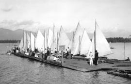 [A group looking at boats on F.W. Fraser's float at Kitsilano Yacht Club at the foot of Balsam St...